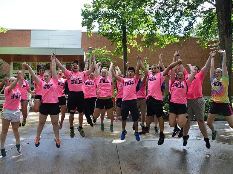 Orientation Leaders jump for a photo on move in day